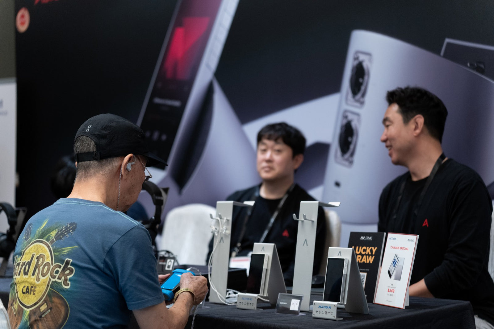 An attendee interacting with a product at the Astell&Kern at CanJam Singapore 2025 event.