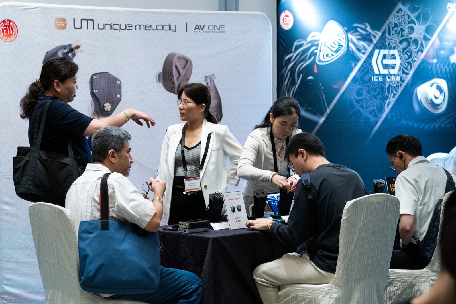 Exhibitors and attendees interacting at the Unique Melody booth at CanJam Singapore 2025 event.
