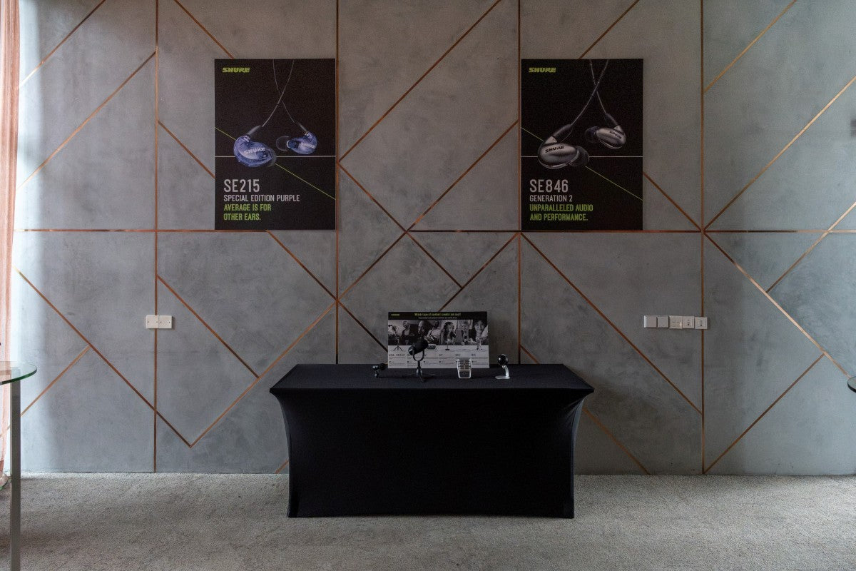 Large posters of Shure SE846 Gen 2 and SE215 Special Edition Purple featured on the wall with MOTIV Microphones on display below them.