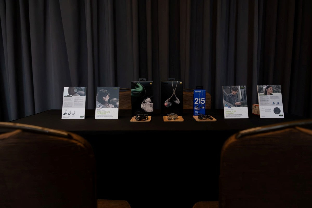 The Shure SE846 Gen 2 and SE215 Special Edition Purple products lined up on the table display.