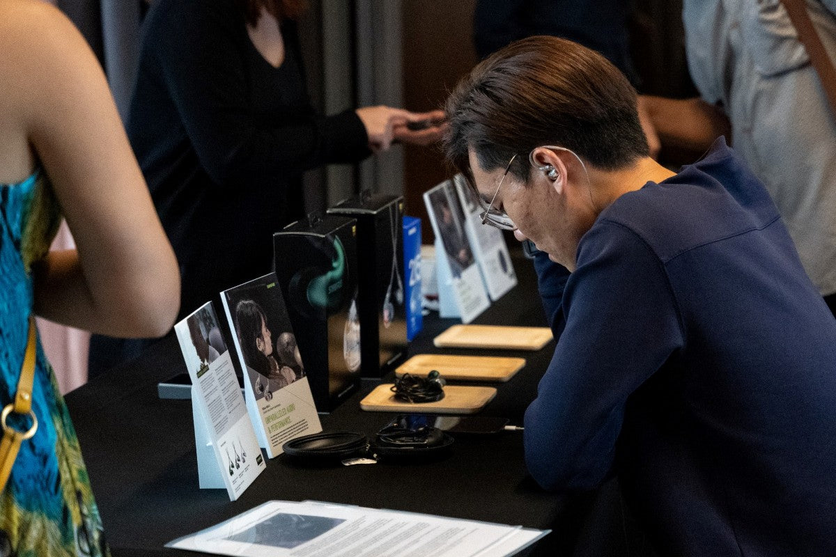 A man auditioning the SE846 Gen 2 in-ear monitors at the Shure Media Event.